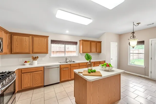 a kitchen with a sink stove and window