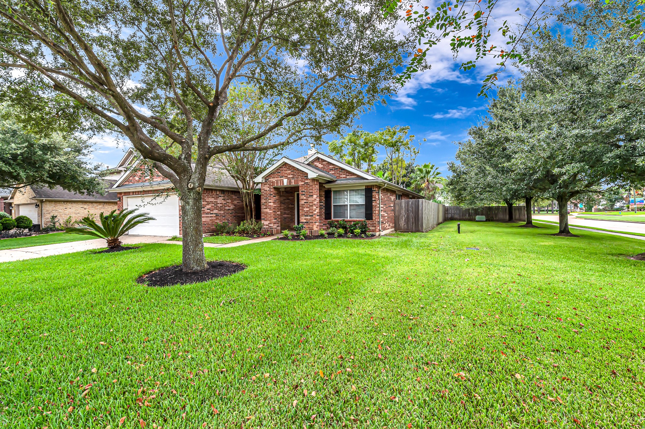 1602 Rustic Hollow Lane Katy, TX 77450 - Photo 2 of 48 Beautiful brick exterior on an oversized corner lot with mature trees, lush landscaping, and a well-maintained lawn. Offers great curb appeal and a welcoming front entry.