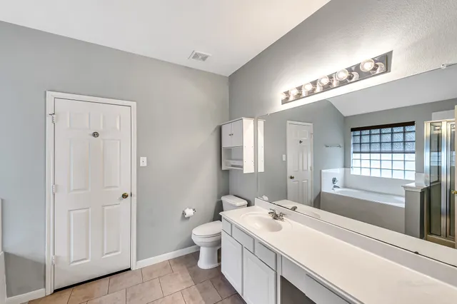 a white bath tub sitting in a bathroom next to a window