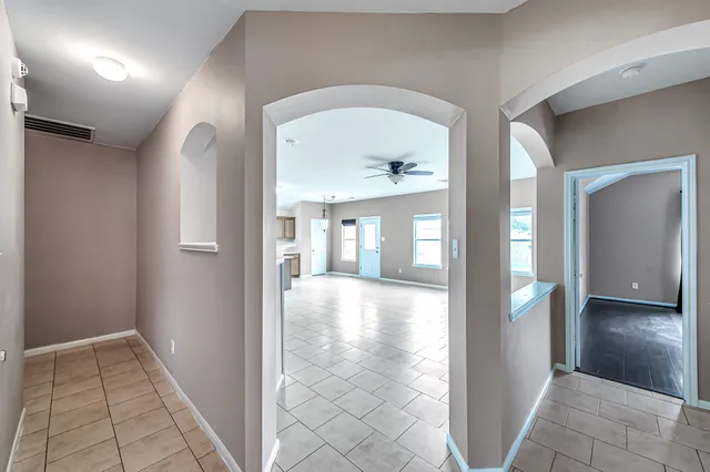 a view of backyard with wooden fence