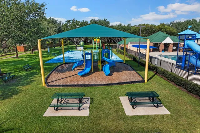 an aerial view of a house with pool patio and outdoor seating