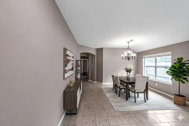 a dining room with furniture and chandelier