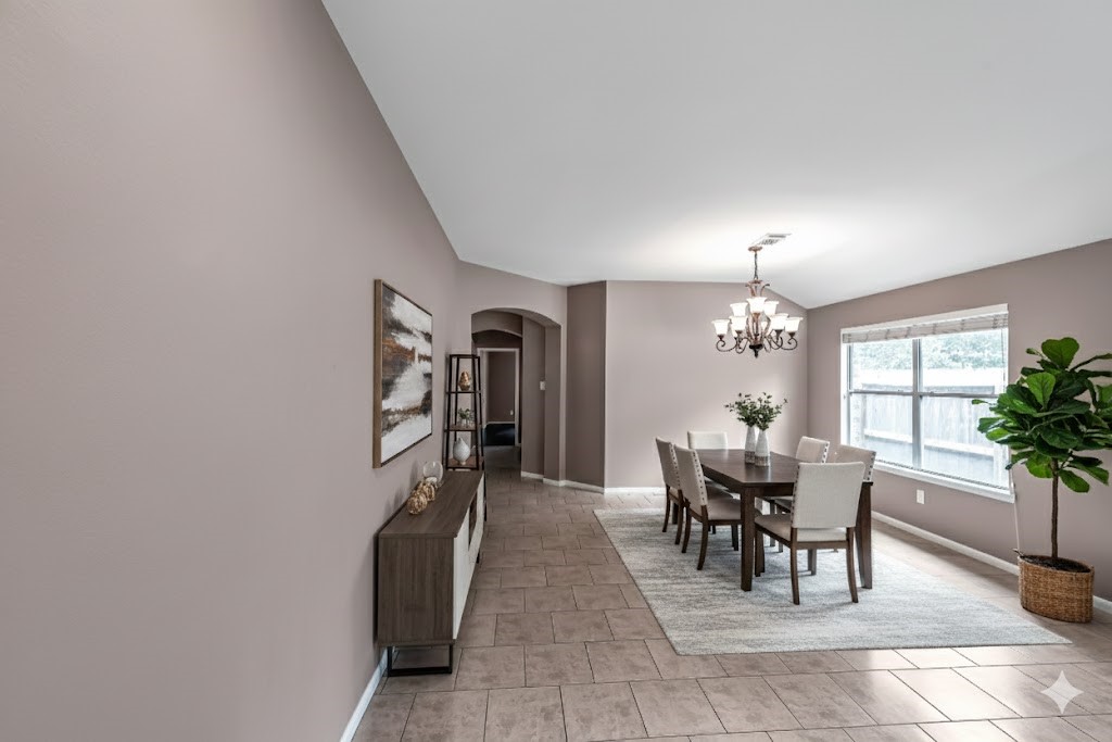 1602 Rustic Hollow Lane Katy, TX 77450 - Photo 7 of 48 Bright and spacious dining area featuring large windows for natural light, tile flooring, neutral tones, and an elegant chandelier.