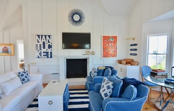 a living room with furniture a flat screen tv and a fireplace