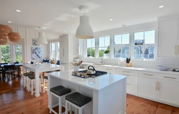 a kitchen with a sink cabinets and wooden floor