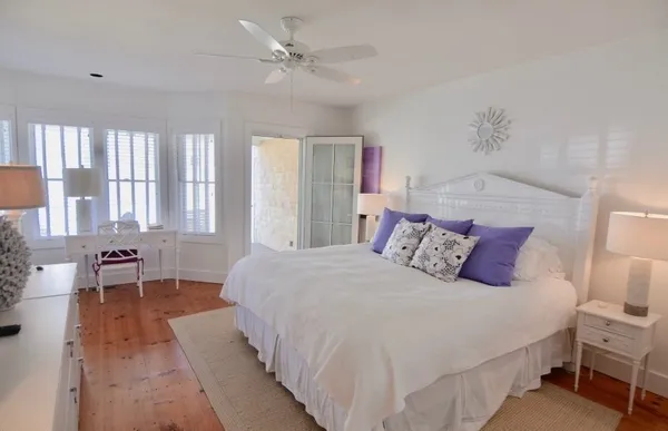 a bedroom with a large bed and a chandelier