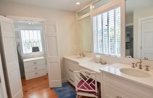 a bathroom with a sink a vanity and a large mirror