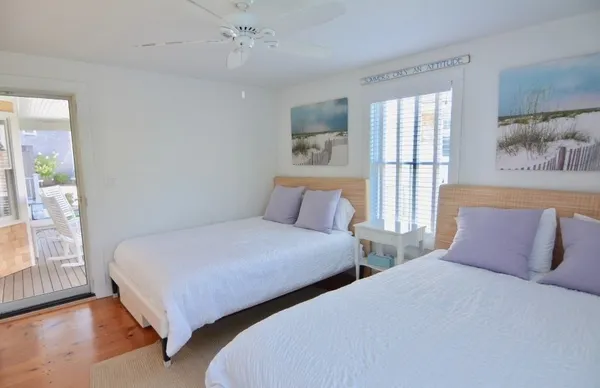 a bedroom with two beds and a large window