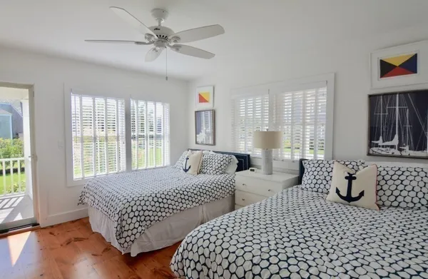 a bedroom with two beds and a window