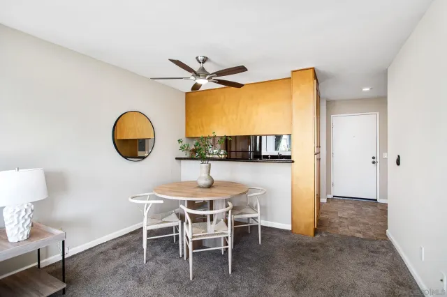 a dining room with furniture and a window