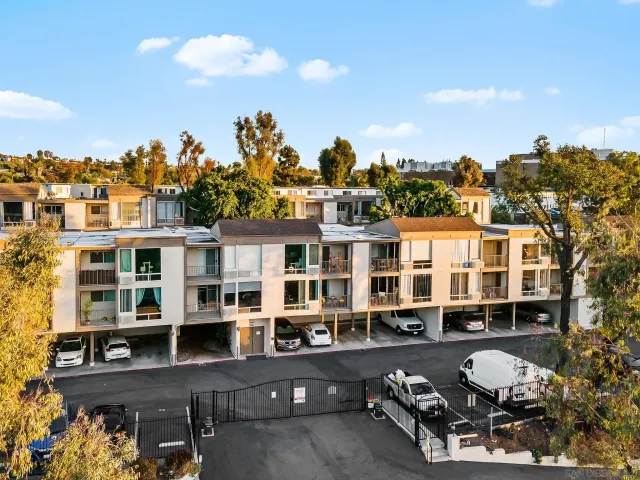 an aerial view of a house with a garden and lake view