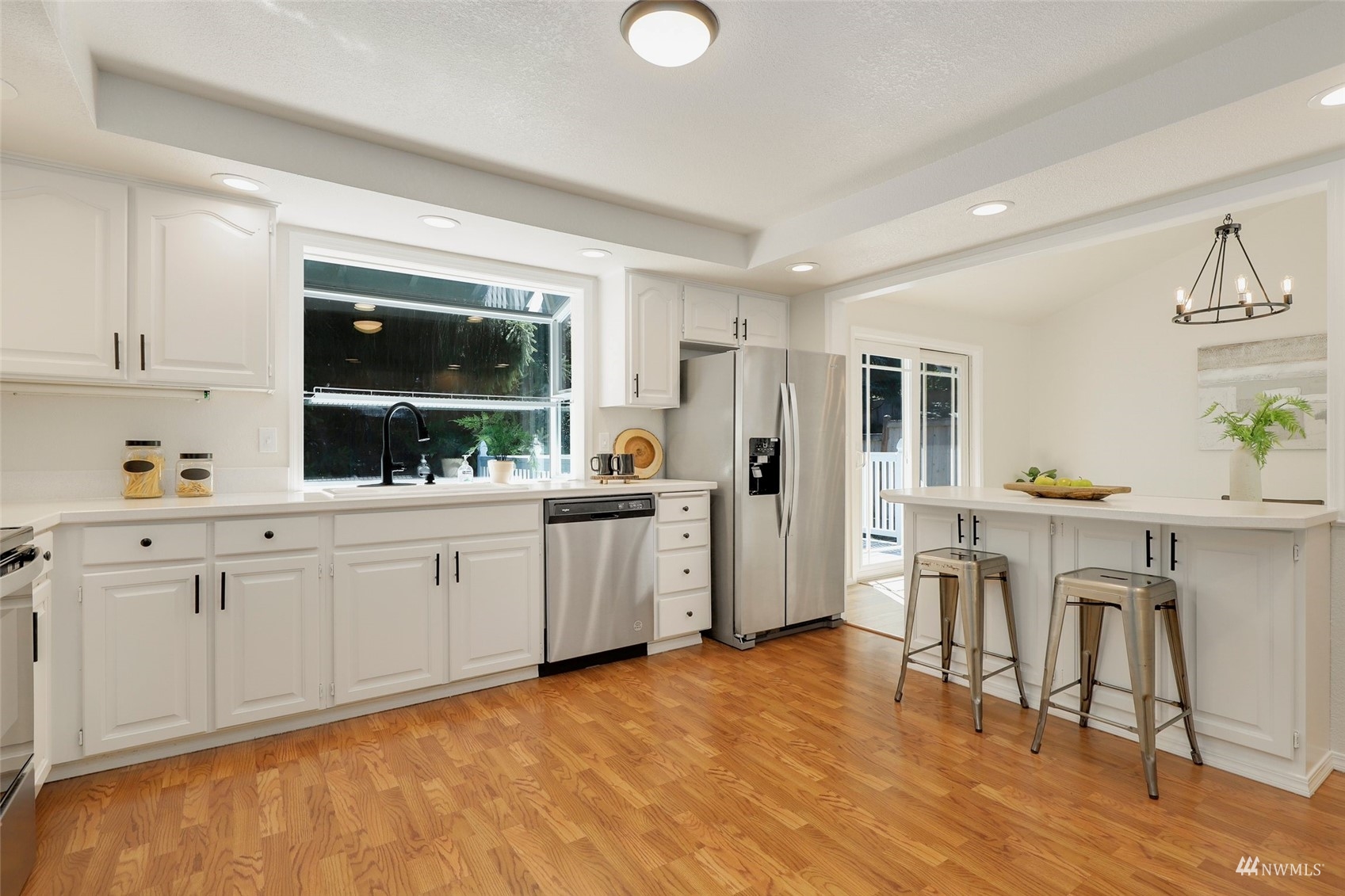 22019 2nd Place West Bothell, WA 98021 - Photo 12 of 40 a kitchen with white cabinets and sink