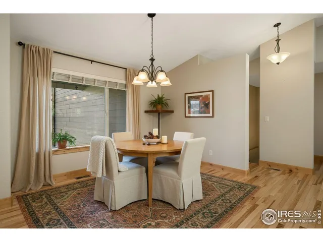 a kitchen with stainless steel appliances granite countertop a sink a stove and a wooden floors