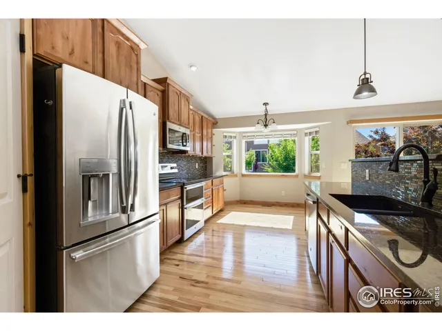 a bedroom with a bed a couch and window