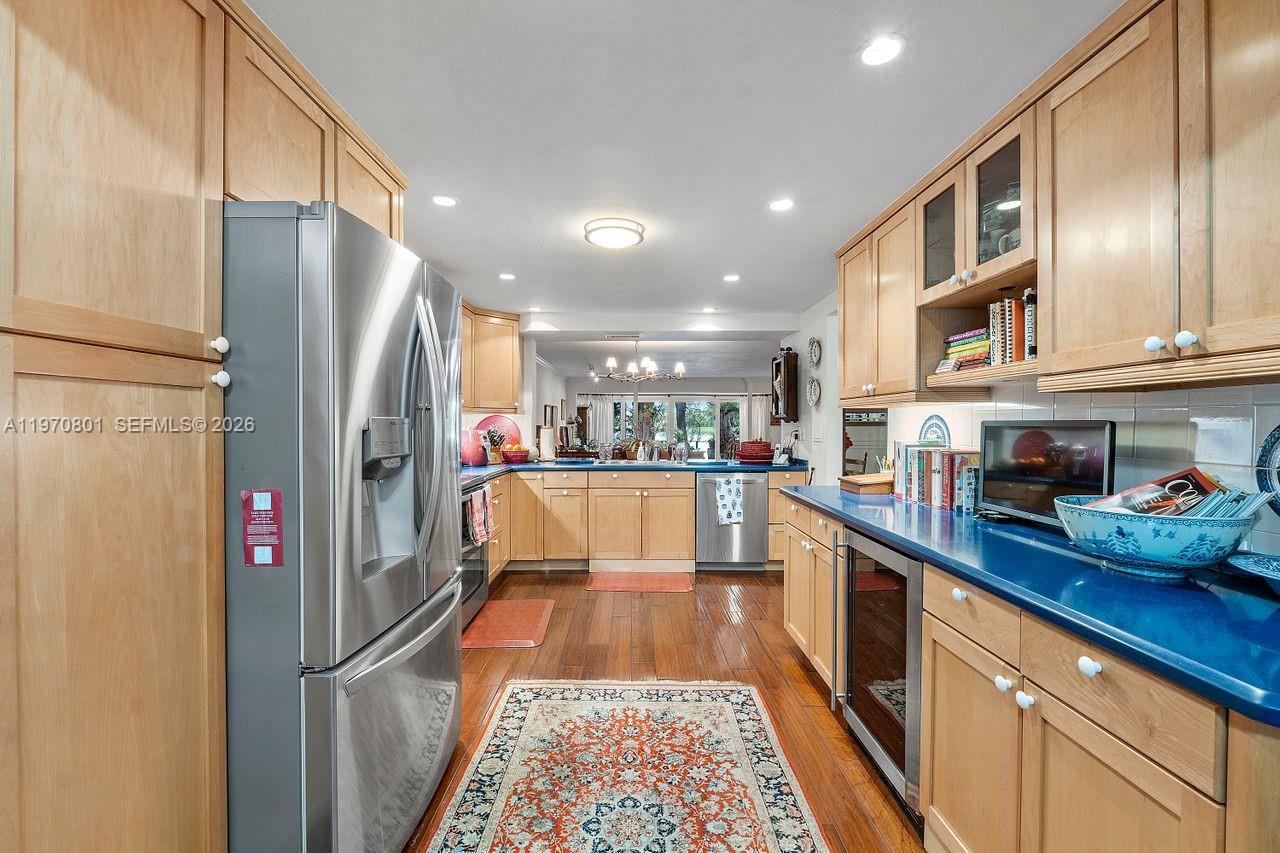 4905 Southwest 71st Place Miami, FL 33155 - Photo 11 of 37 a kitchen with stainless steel appliances granite countertop a refrigerator and a sink