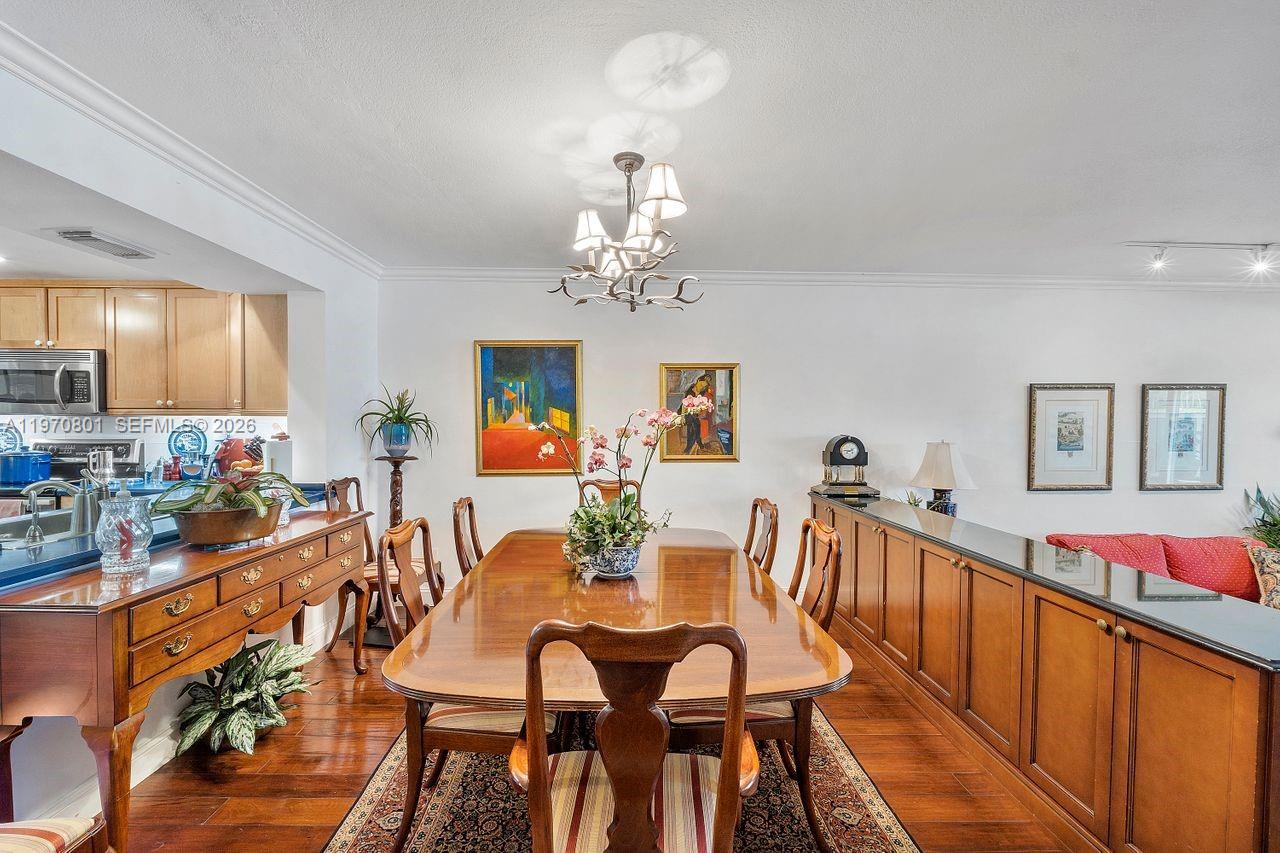 4905 Southwest 71st Place Miami, FL 33155 - Photo 15 of 37 a view of a dining room with furniture and chandelier