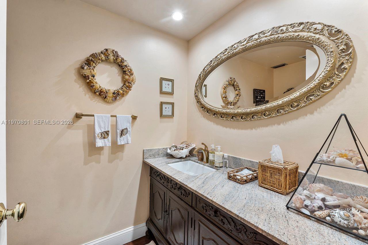 4905 Southwest 71st Place Miami, FL 33155 - Photo 21 of 37 a bathroom with a granite countertop sink and mirror