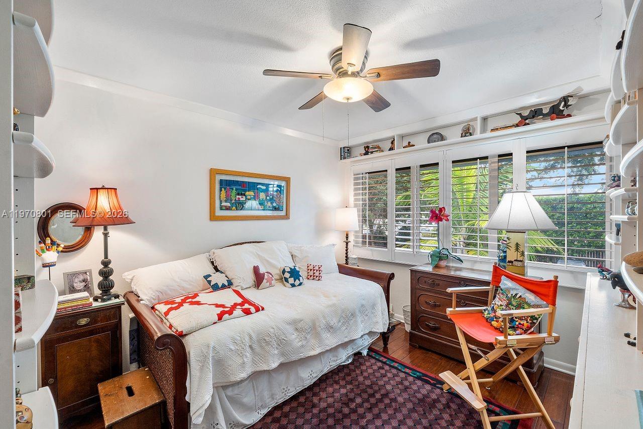 4905 Southwest 71st Place Miami, FL 33155 - Photo 27 of 37 a bedroom with a bed and a chandelier