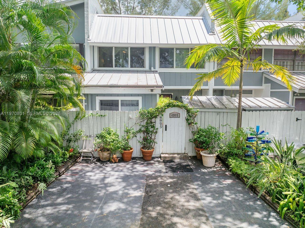 4905 Southwest 71st Place Miami, FL 33155 - Photo 3 of 37 a view of a house with a yard and sitting area
