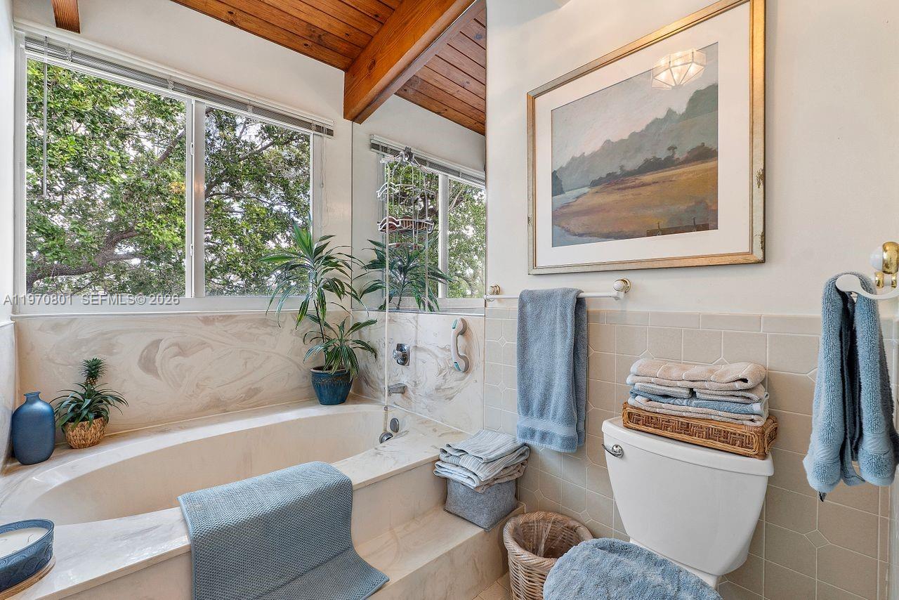 4905 Southwest 71st Place Miami, FL 33155 - Photo 32 of 37 a bathroom with a tub and a potted plant