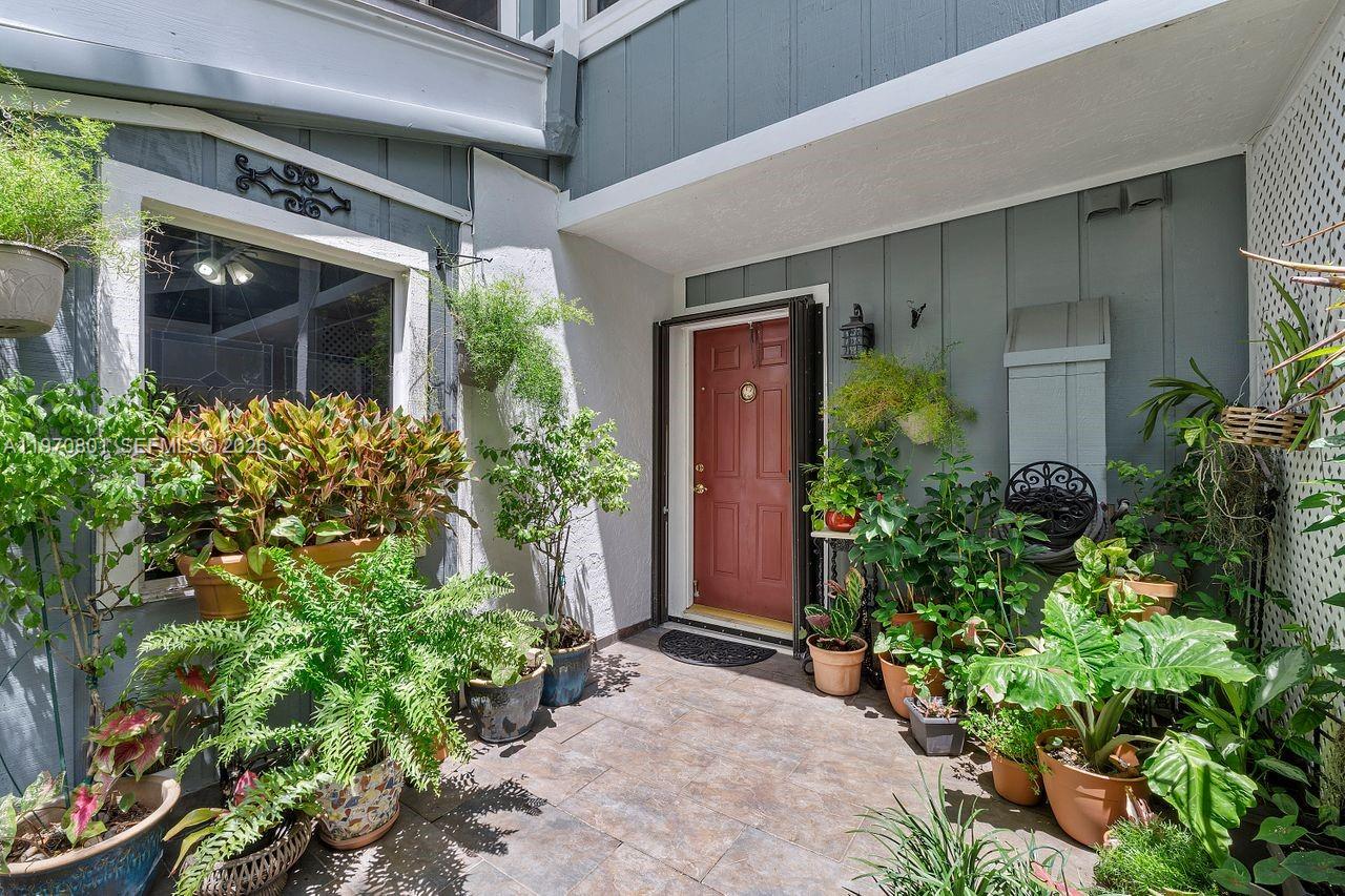 4905 Southwest 71st Place Miami, FL 33155 - Photo 4 of 37 front view of a house with potted plants