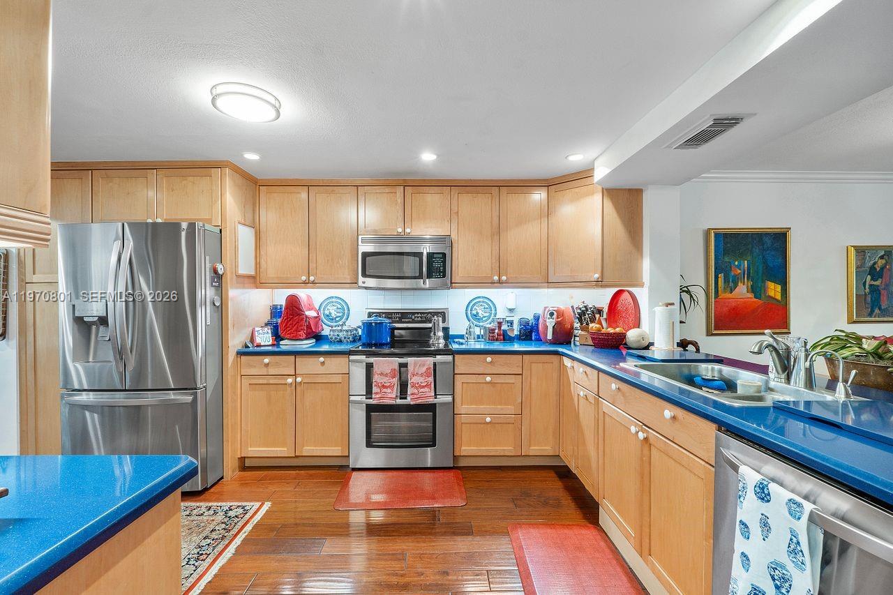 4905 Southwest 71st Place Miami, FL 33155 - Photo 10 of 37 a kitchen with stainless steel appliances granite countertop a refrigerator and a sink