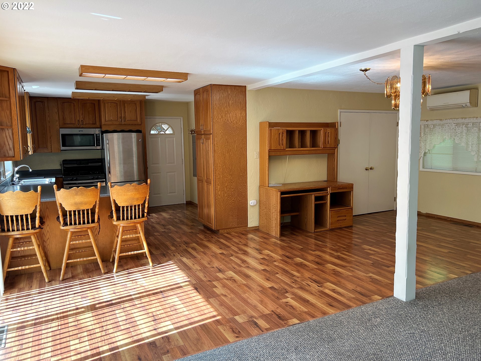 96068 Sundown Road Brookings, OR 97415 - Photo 9 of 31 a living room with fireplace furniture and a wooden floor