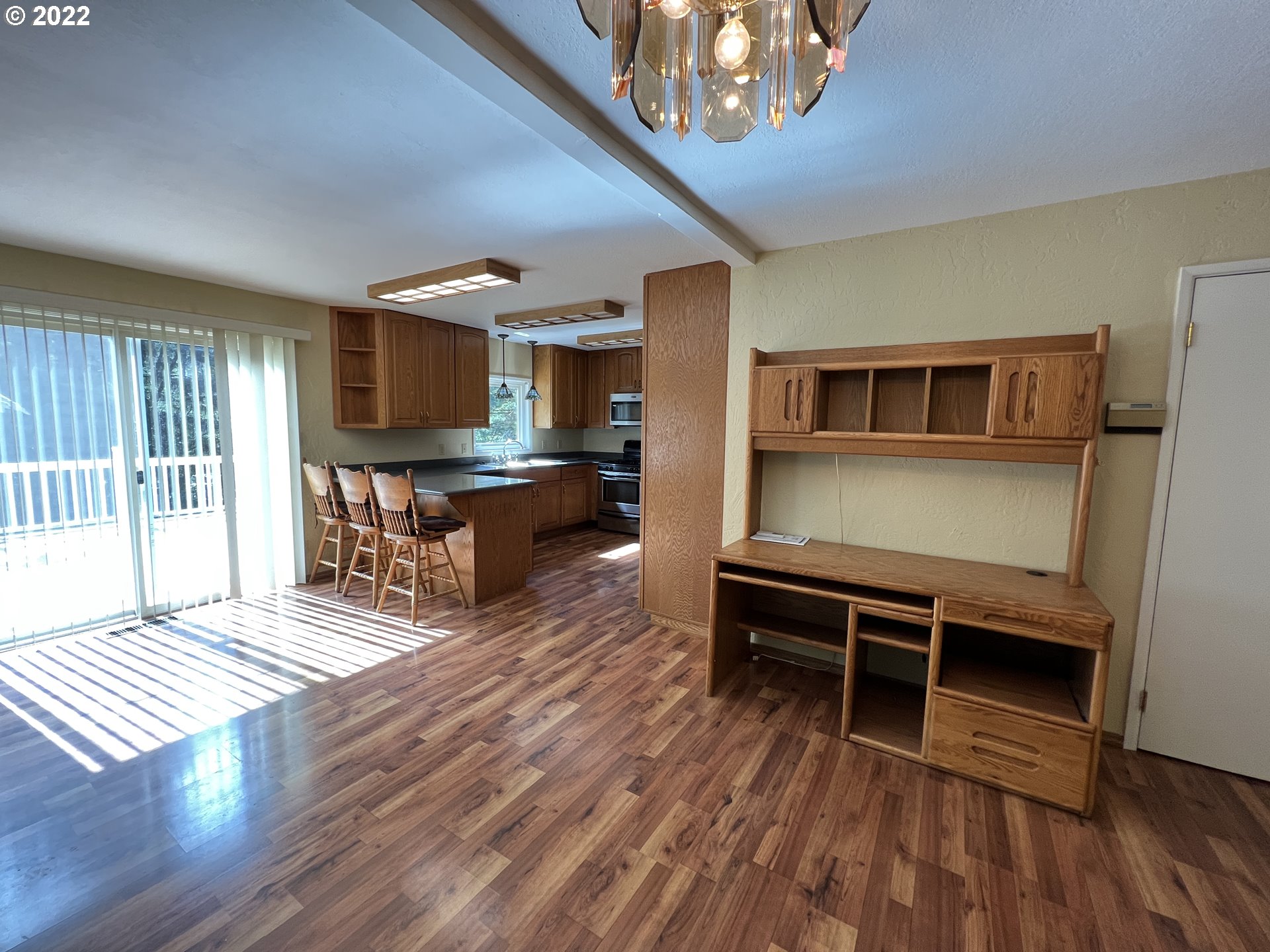 96068 Sundown Road Brookings, OR 97415 - Photo 10 of 31 a living room with furniture a fireplace and a wooden floor