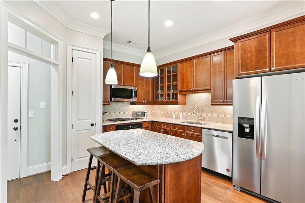 3635 East Paces Circle, Unit 1410 Atlanta, GA 30326 - Photo 16 of 68 a kitchen with stainless steel appliances granite countertop a sink refrigerator and cabinets