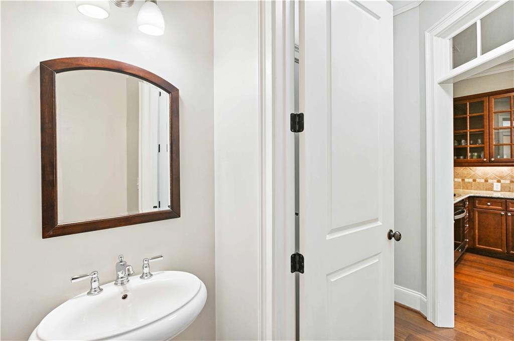 3635 East Paces Circle, Unit 1410 Atlanta, GA 30326 - Photo 22 of 68 a bathroom with a sink and mirror