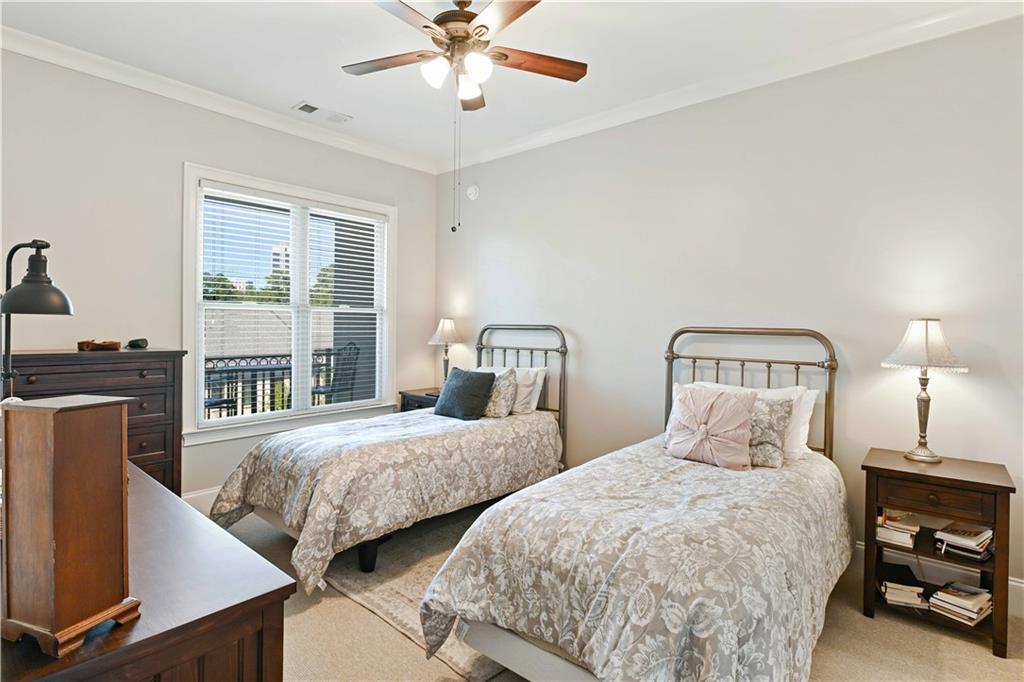 3635 East Paces Circle, Unit 1410 Atlanta, GA 30326 - Photo 23 of 68 a bedroom with two beds and a window