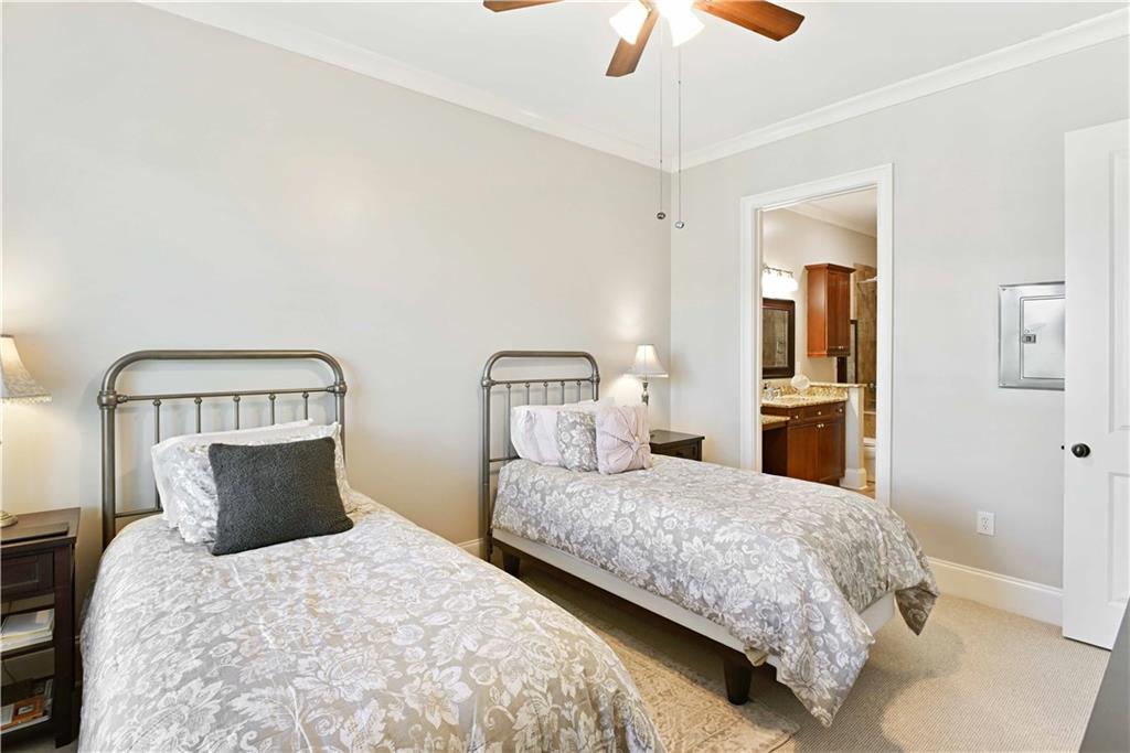 3635 East Paces Circle, Unit 1410 Atlanta, GA 30326 - Photo 25 of 68 a bedroom with a bed and ceiling fan