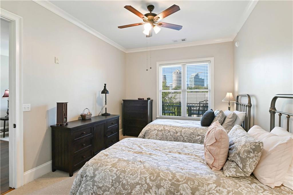 3635 East Paces Circle, Unit 1410 Atlanta, GA 30326 - Photo 31 of 68 a bedroom with a bed and a window