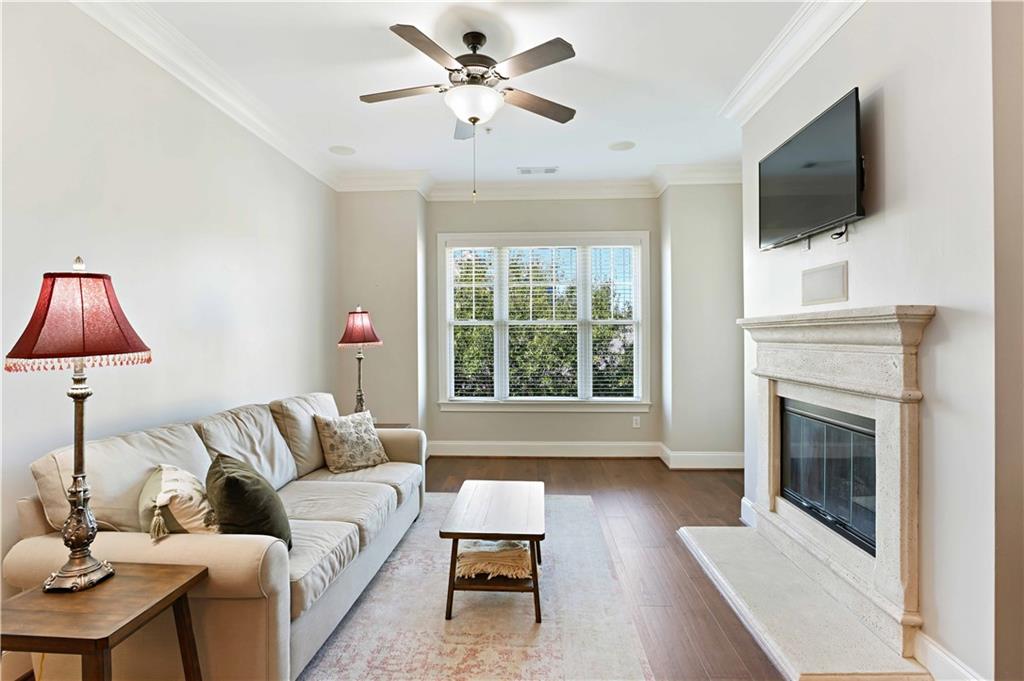 3635 East Paces Circle, Unit 1410 Atlanta, GA 30326 - Photo 4 of 68 a living room with furniture a fireplace and a flat screen tv