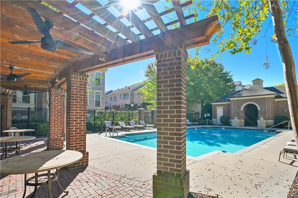 3635 East Paces Circle, Unit 1410 Atlanta, GA 30326 - Photo 45 of 68 a view of a porch with couches potted plants and wooden floor