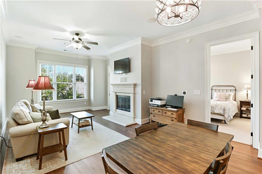 3635 East Paces Circle, Unit 1410 Atlanta, GA 30326 - Photo 5 of 68 a living room with furniture a fireplace and a table