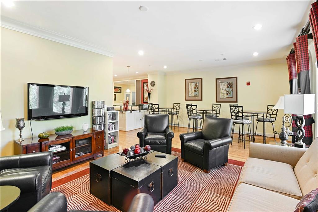 3635 East Paces Circle, Unit 1410 Atlanta, GA 30326 - Photo 56 of 68 a living room with furniture a rug and a flat screen tv