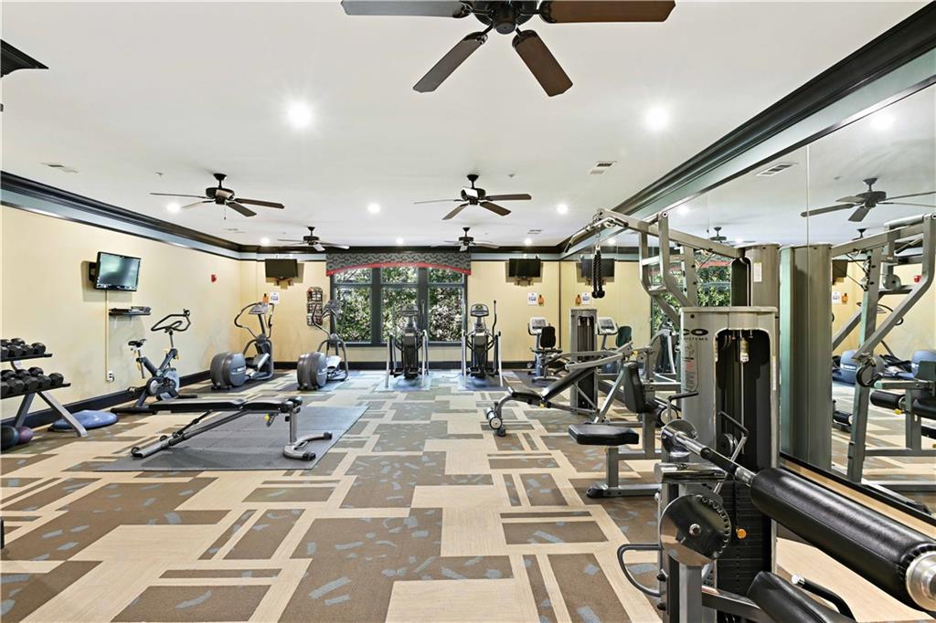 3635 East Paces Circle, Unit 1410 Atlanta, GA 30326 - Photo 58 of 68 a view of a room with gym equipment