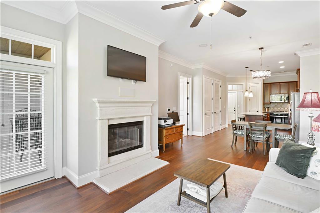 3635 East Paces Circle, Unit 1410 Atlanta, GA 30326 - Photo 6 of 68 a living room with furniture a fireplace and a flat screen tv