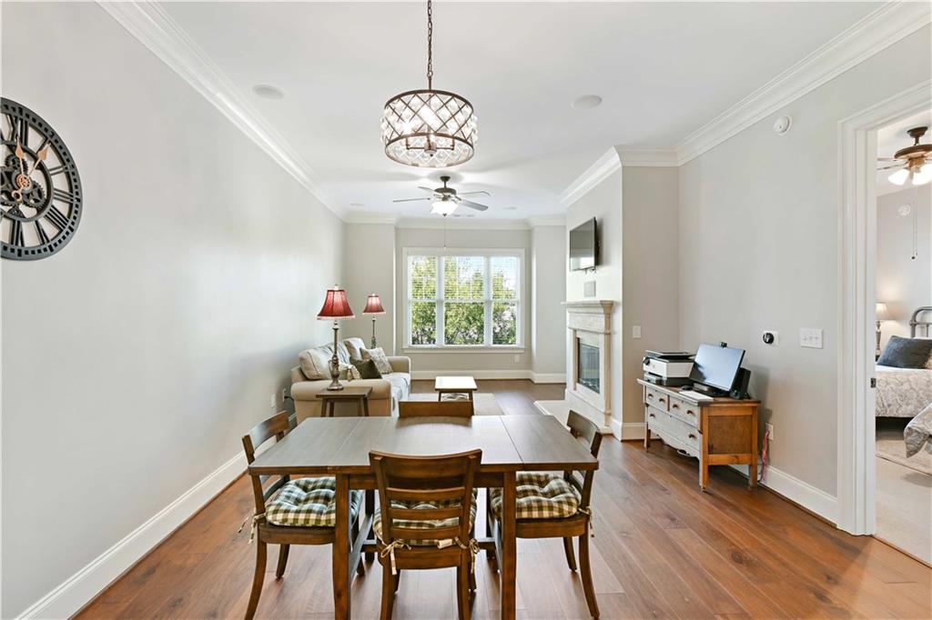 3635 East Paces Circle, Unit 1410 Atlanta, GA 30326 - Photo 9 of 68 a view of a dining room with furniture wooden floor and a chandelier