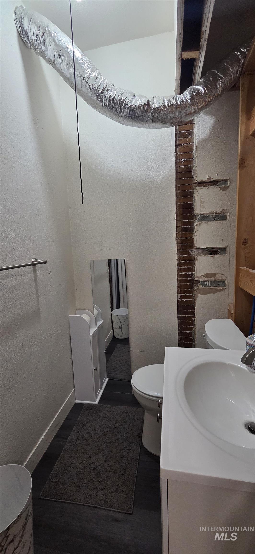509 16th Street Lewiston, ID 83501 - Photo 7 of 10 Half bath with vanity and wood finished floors