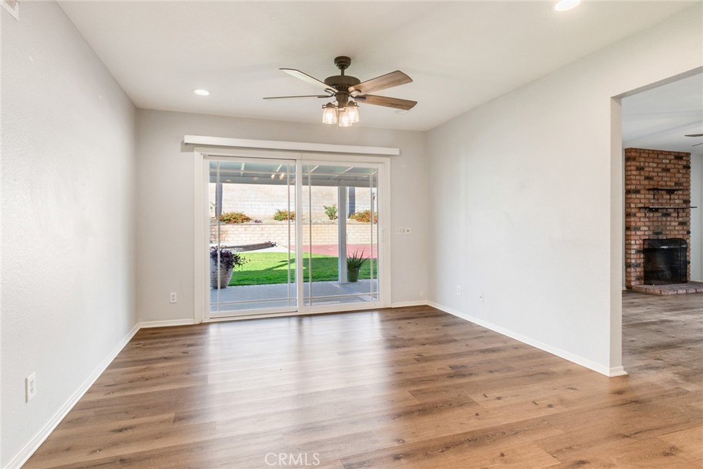8358 Garden Street Rancho Cucamonga, CA 91701 - Photo 11 of 28 a view of an empty room with wooden floor and a window