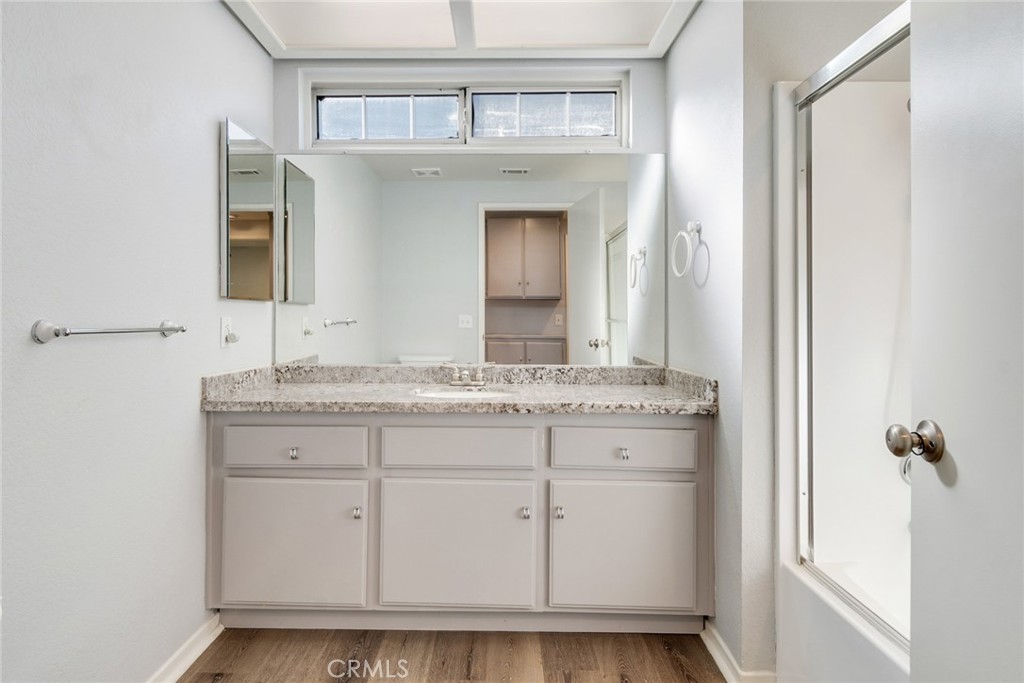 8358 Garden Street Rancho Cucamonga, CA 91701 - Photo 16 of 28 a bathroom with a granite countertop sink and a mirror