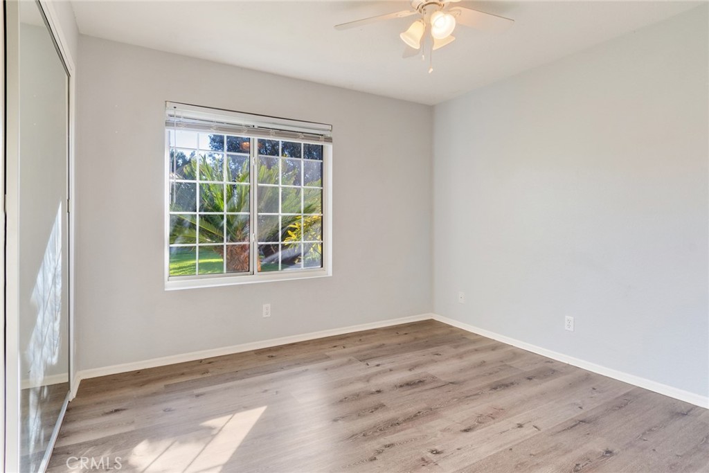 8358 Garden Street Rancho Cucamonga, CA 91701 - Photo 17 of 28 an empty room with wooden floor and windows