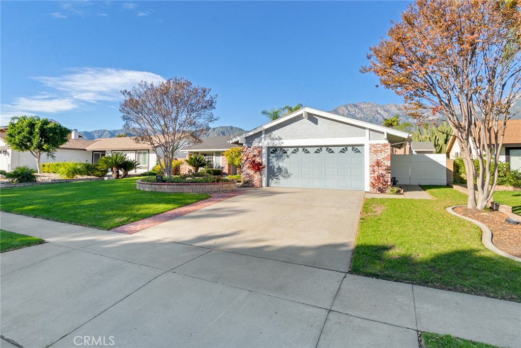 8358 Garden Street Rancho Cucamonga, CA 91701 - Photo 2 of 28 a view of a house with a yard
