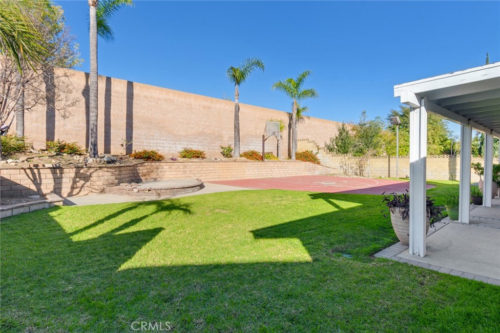 8358 Garden Street Rancho Cucamonga, CA 91701 - Photo 21 of 28 a view of a swimming pool with a lawn chairs under an umbrella