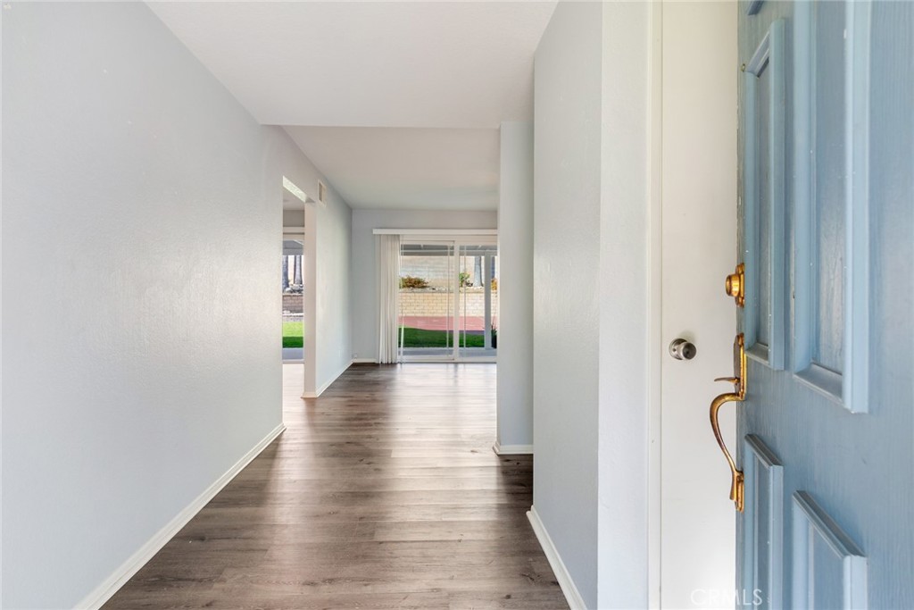 8358 Garden Street Rancho Cucamonga, CA 91701 - Photo 3 of 28 a view of a hallway with wooden floor