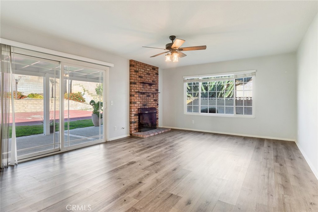 8358 Garden Street Rancho Cucamonga, CA 91701 - Photo 4 of 28 a view of an empty room with wooden floor and a window