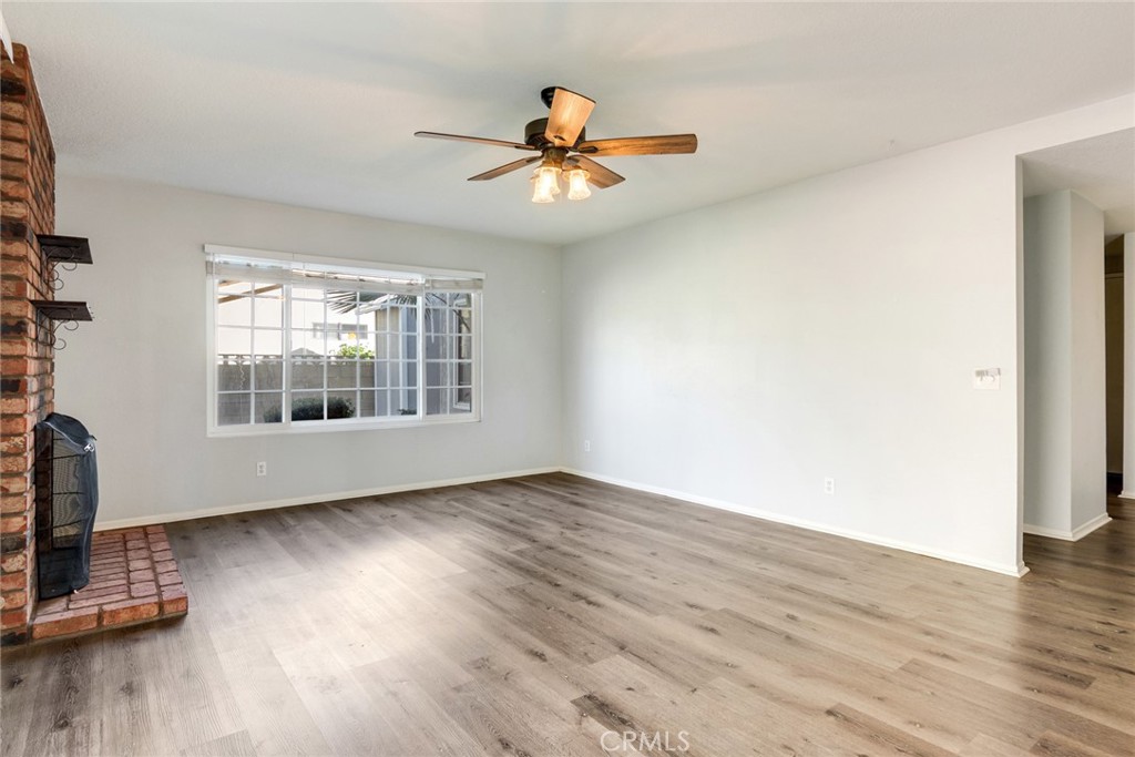 8358 Garden Street Rancho Cucamonga, CA 91701 - Photo 5 of 28 a view of an empty room with wooden floor and a window
