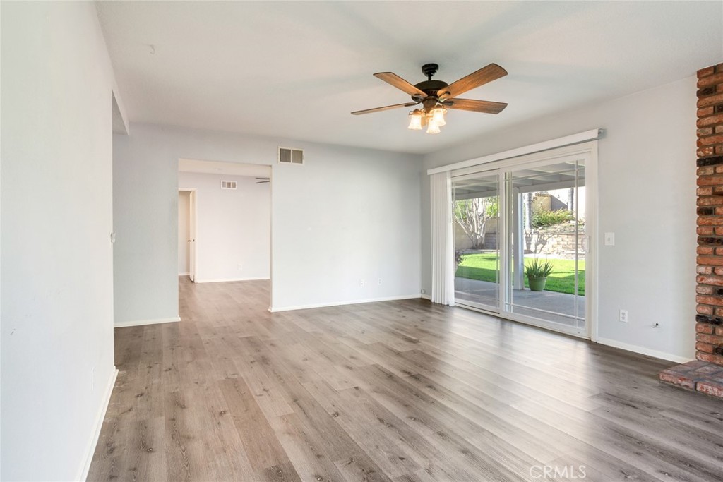 8358 Garden Street Rancho Cucamonga, CA 91701 - Photo 6 of 28 a view of an empty room with wooden floor and a window
